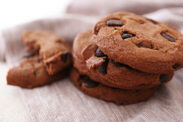 Fresh oat biscuits with chocolate on napkin, closeup