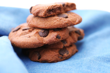 Fresh oat biscuits with chocolate on napkin, closeup