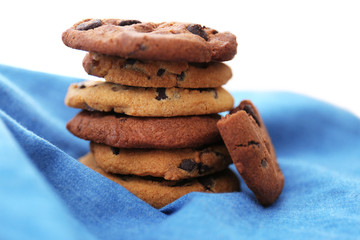 Fresh oat biscuits with chocolate on napkin, closeup
