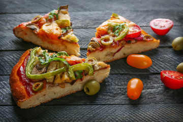 Tasty homemade pizza slices on table
