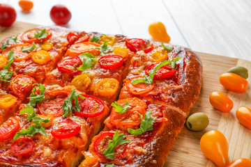 Tasty homemade pizza slices on table