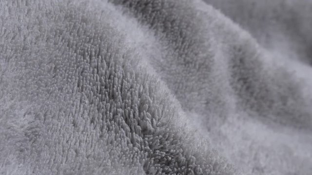 Polar fleece silver fabric warm material close-up 2160p 30fps UltraHD tilting footage - Slow tilt over gray color synthetic fibers of blanket texture 4K 3840X2160 UHD video