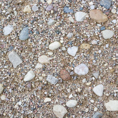 Rural road close-up. Stone and sand texture or background.