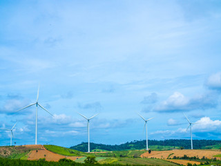 Fototapeta na wymiar Wind turbines on mountain view; top space for text