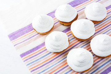 Obraz na płótnie Canvas Homemade cupcakes with white whipped cream top view