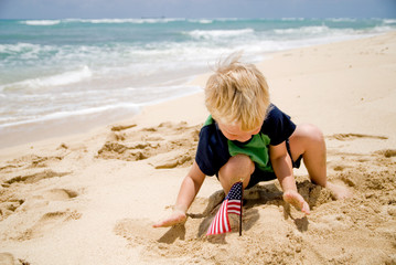 Little boy with an American flag on the beach