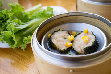 dimsum - steamed pork wrapped with seeweed in bamboo basket
