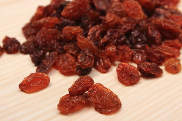 Brown raisins on wooden table, healthy eating