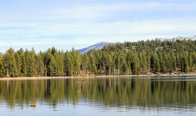 Calm Lake/Reflection of trees on calm lake.