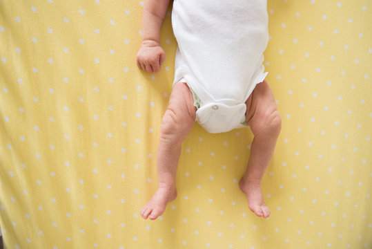 newborn baby on yellow blanket 