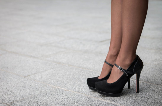 Woman wearing a pair of black classic high heels