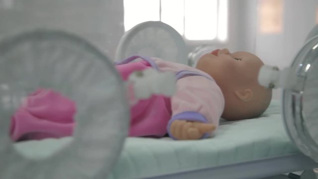 Doll in an incubator for premature babies