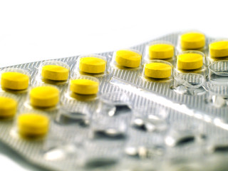 Yellow pills in blister pack macro, shallow depth of field
