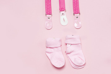 Cotton baby socks for newborn on a colorful pink background. Copy space