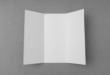 Trifold white template paper on gray  background .