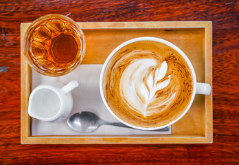 Latte Coffee art on the wooden table .