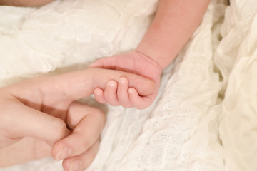 Fototapeta na wymiar Mother's and daughter baby fingers hands
