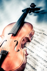 Fototapeta premium Old violin lying on the sheet of music, music concept