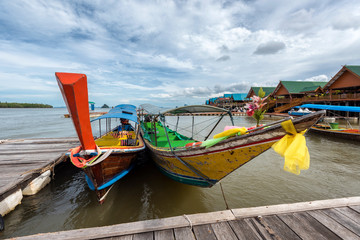Fototapeta na wymiar Long boats used for fishing and touring at Koh Panyee, Thailand, a Muslim fishing village outside Phuket
