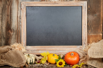 Blackboard in autumn with pumkins and sunflower - 121431576