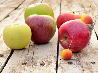Variety of apples on wooden background