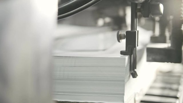 Printed sheets of paper are served in the printing press. Offset printing, CMYK