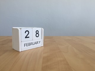 February 28th. Cube calendar for february 28 on wooden surface w