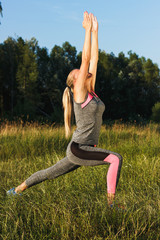 Young woman makes yoga exercises