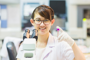 Medical technician holding blood tube in laboratory : Picture for concept of hospital, medical, health, clinic, physician, doctor, patient, science, geneticist, research and healthcare.