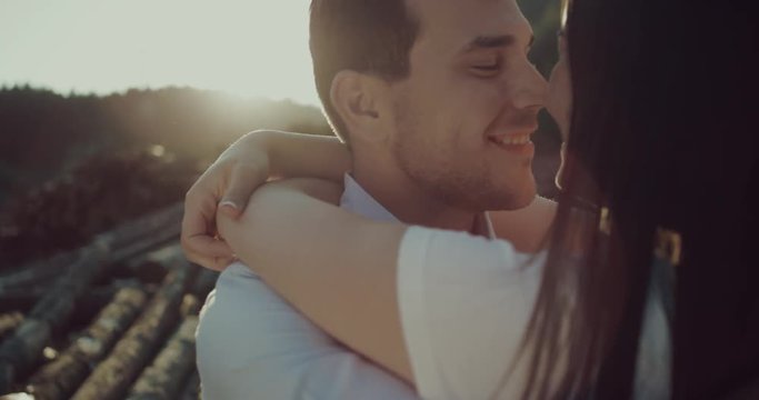 Happy couple meet again embracing in love romantic and fun. Woman running in the arms of her boyfriend man. They start turning around swirling laughing joyful. 