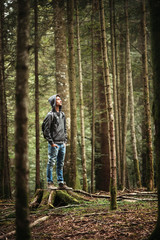 Hooded man posing in the forest