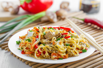 Traditional oriental food made of rice noodles, vegetables, shiitake and tofu. Asian meal.