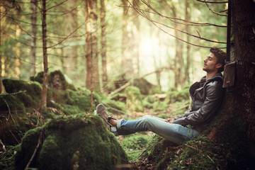 Young man resting in the woods