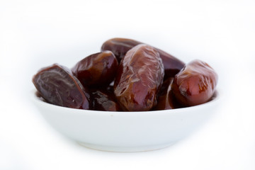 Sweet and healthy dates isolated on white background.