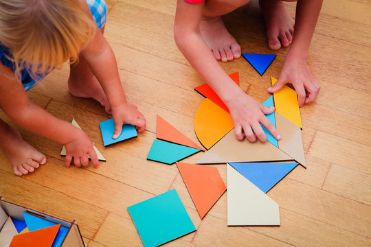 kids learning -little boy and girl playing with geometric shapes