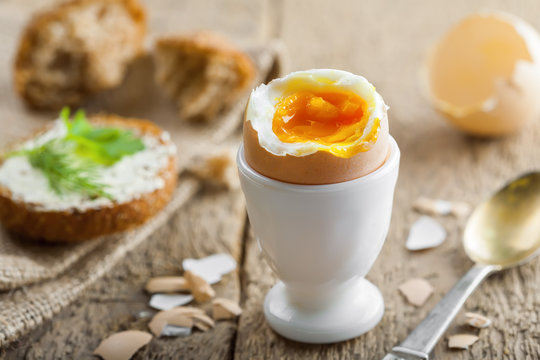 Perfect soft boiled egg with bread and butter for breakfast. Traditional healthy food.