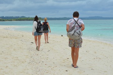  Nungwi Zanzibar Tanzania August 2016 Tourist walking on white sand beach 