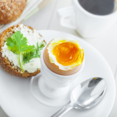 Perfect soft boiled egg, bread and butter with coffee for breakfast. Traditional healthy food. Top view.