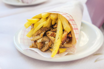 Greek gyro with fries close up on table