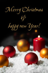 festive christmas card with baubles in the snow and text