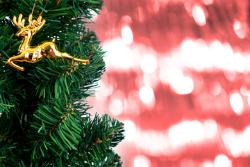 red Christmas background of de-focused lights with Christmas-tre