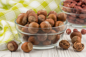 Hazelnut in a glass bowl on the old wooden table.