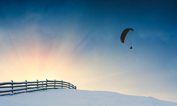 Paraglide over winter valley