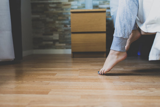 Woman feet on the parquet floor