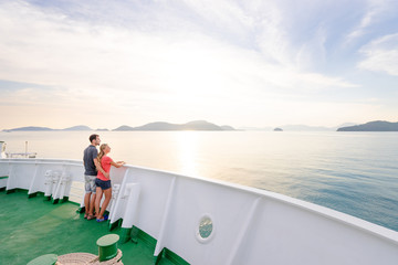 Romantic vacation. Young loving couple enjoying sunset on cruise ship deck. Sailing the sea.