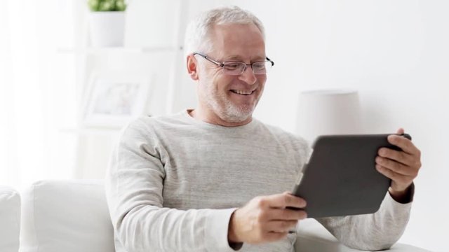 senior man having video call on tablet pc at home 117