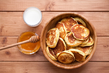 Homemade Pancakes with honey and glass of milk in wooden dish. Pumpkin Pancakes.