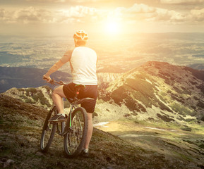 Men with bicycle aroun mountains beautiful view.