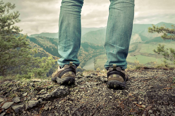 Men stay in Mountains footwear on the beautiful view.