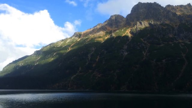 Panoramic image of mountains and mountain lake.
